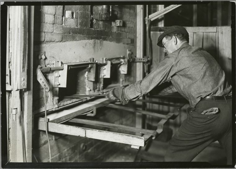 man-operating-a-brick-oven